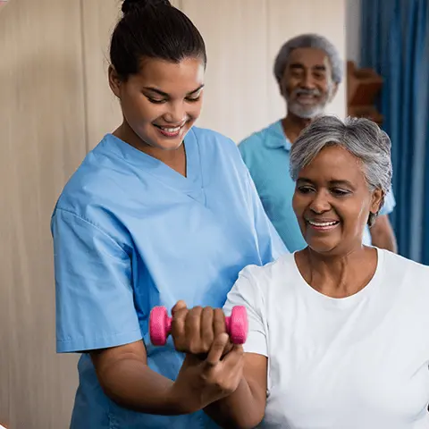 nurse assisting client with arm weight training