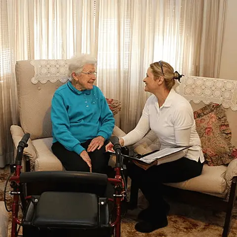 senior woman chatting with a Vital Home Health Services nurse